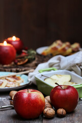Naklejka na ściany i meble Red apples and walnuts on the table. Christmas eve.