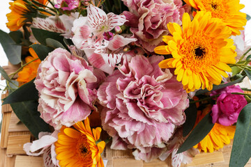 A colorful bouquet of flowers with gerberas and carnations.