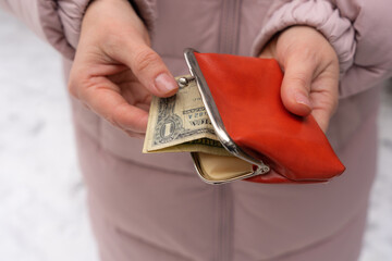 hand holding a wallet with money