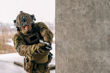 Special forces operator wearing Multicam uniform and his handgun xdm 9mm while practicing CQB...