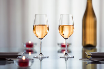 Glasses of wine, and candlelight dinner table setting