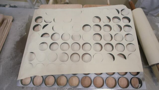 Food industry. Man rolled out the dough, prepares dough for dumplings. High quality 4k footage