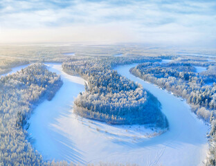 Winter landscape. Aerial view. Landscape with winding river and snowy forest in Western Siberia....