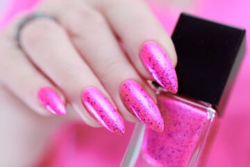 beautiful Female hands with long nails and neon pink nail polish