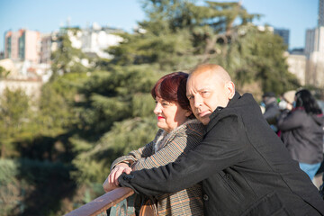 couple man looking at camera and senior caucasian woman looking at the landscape