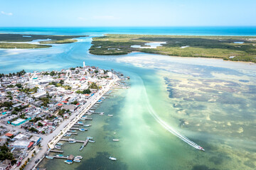 Aerial landscape overlooking the city of Rio Lagartos. The city is surrounded by a beautiful river with azure water. Fishing boats are moored to the shore. Yucatan, Mexico