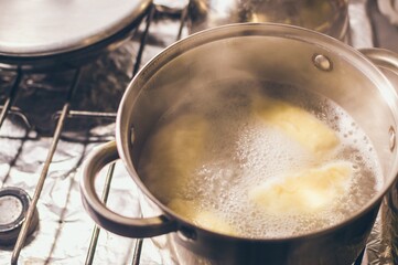 Dumplings with cottage cheese in boiling water in large saucepan
