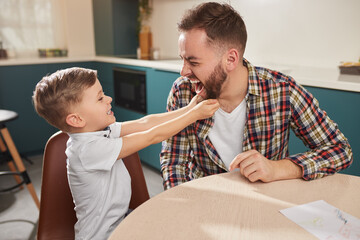 Father and son having fun at home