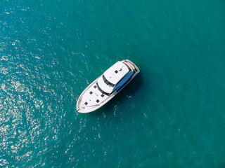 Awesome aerial top view photo of a laxury enormous two-storey yach sailing across the deer sea