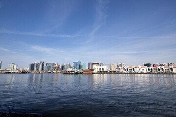 Naklejka premium View of the city of Dubai from a boat in the old Abra port, UAE