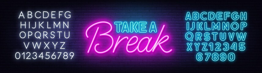 Take a Break neon quote on a brick wall.
