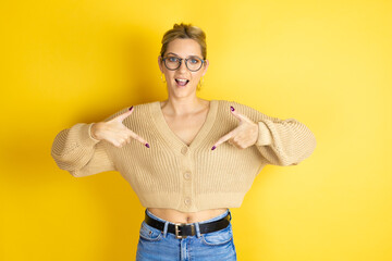 Young beautiful woman wearing casual sweater over isolated yellow background looking confident with...