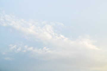 Pale blue sky with small clouds