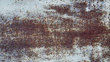 Texture of a painted metal wall covered with rust
