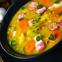 Hearty rustic pea soup with bacon and sausage
