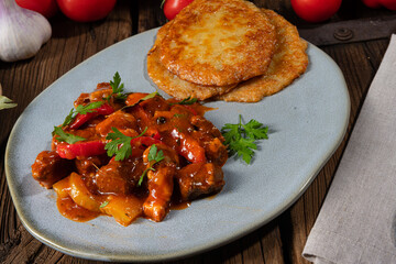 Original Hungarian goulash with potato pancakes