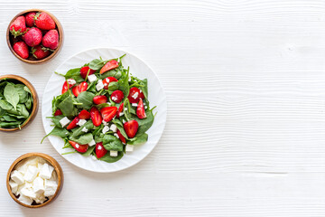 Vegetarian lunch spinach and strawberry salad. Top view
