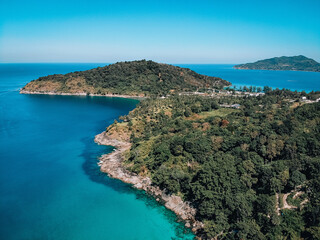 Fototapeta na wymiar Drone view of the lagoon: narrow strip of the white sand, clear blue water and green hills covered with tropical forest; paradise concept.