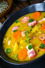 Hearty rustic pea soup with bacon and sausage