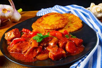 Original Hungarian goulash with potato pancakes