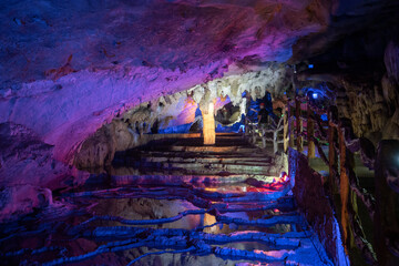Underground karst cave illuminated by color light.