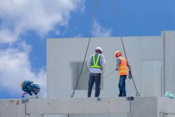 Construction worker are installing the precast concrete beam at housing estate, build a house,...