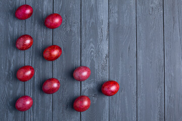 Beautiful Easter eggs on gray wooden background, copy space, flat lay
