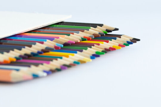 Set of colored watercolor pencils in a box isolated on a white background