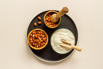 Pestle peanut flour - nuts with mortar on kitchen table