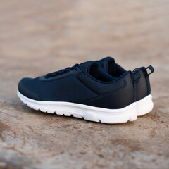 blue sneakers with white soles on an industrial background
