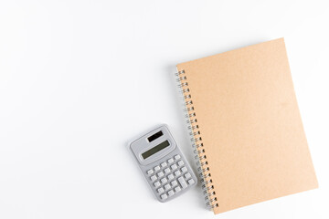 Notebook, calculator and pen isolated on white background. Empty  blank space for copy space. business and educational concept.