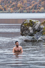 Man bathing in a lake in Norway
