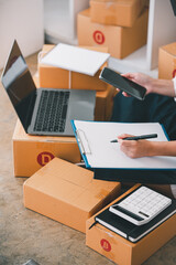 Small start-up business owners checking parcels at work, freelancers, salespeople, checking production orders. Pack products for delivery to customers Sell ​​Ecommerce Shipping Ideas