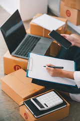Small start-up business owners checking parcels at work, freelancers, salespeople, checking production orders. Pack products for delivery to customers Sell ​​Ecommerce Shipping Ideas
