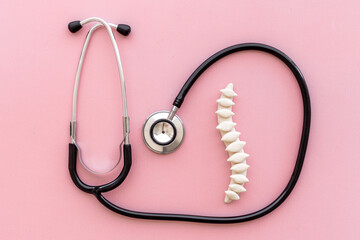 Human medical spine model with stethoscope. Health spinal column care