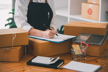Small start-up business owners checking parcels at work, freelancers, salespeople, checking production orders. Pack products for delivery to customers Sell ​​Ecommerce Shipping Ideas
