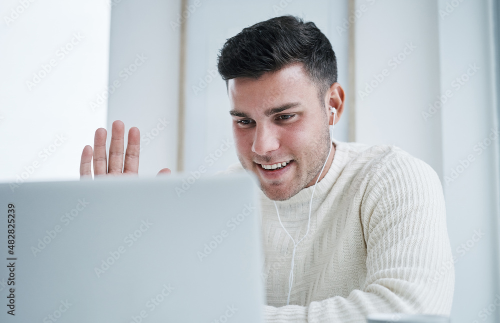 Poster Hope everyone is doing well. Shot of a young man using a laptop to make a video call while working from home.