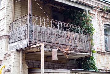 Old emergency balcony on the facade of an abandoned house.