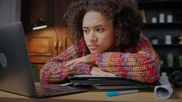 Deadline. Desperate african american woman freelancer looking at laptop with hopelessness, suffering from lots of work