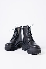 Women's black leather boots on a white background. Shoes and options for its layout. Autumn shoes. Boots. Autumn boots. Shoes close up