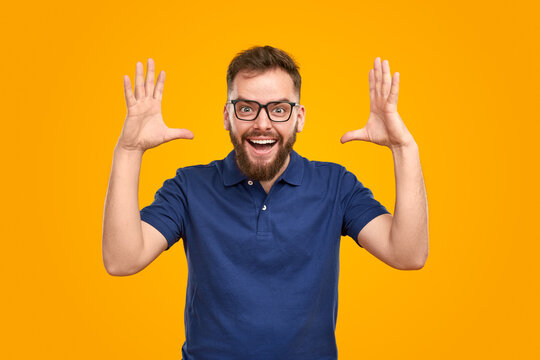 Excited man showing huge object in studio