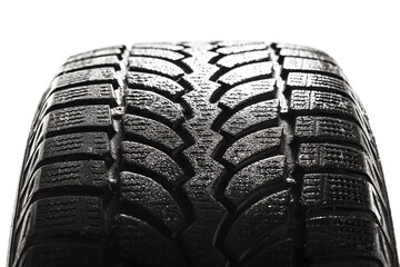 Wet car winter tire isolated on white background. Rubber tyre cover patern..