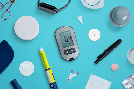 Diabetes supplies and devices on desk. Top view flat lay composition