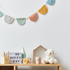 Stylish scandinavian newborn baby room with toys, plush animal, photo camera and child accessories....