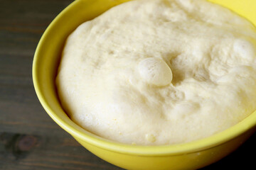 Closeup the Texture of fluffy risen dough in a mixing bowl