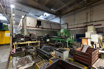 Naklejka premium Photo of modern automatic automobile manufacturing workshop. The interior of a big industrial building of factory with steel constructions. Plant of car production. Industrial concept