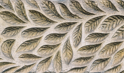 Stone wall with carved floral pattern