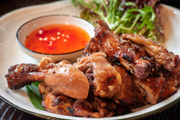 Roasted chicken in Thai style with dip-sauce.