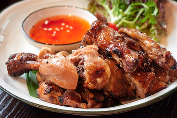 Roasted chicken in Thai style with dip-sauce.