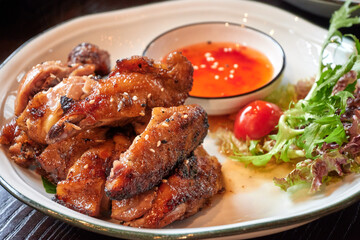 Roasted chicken in Thai style with dip-sauce.